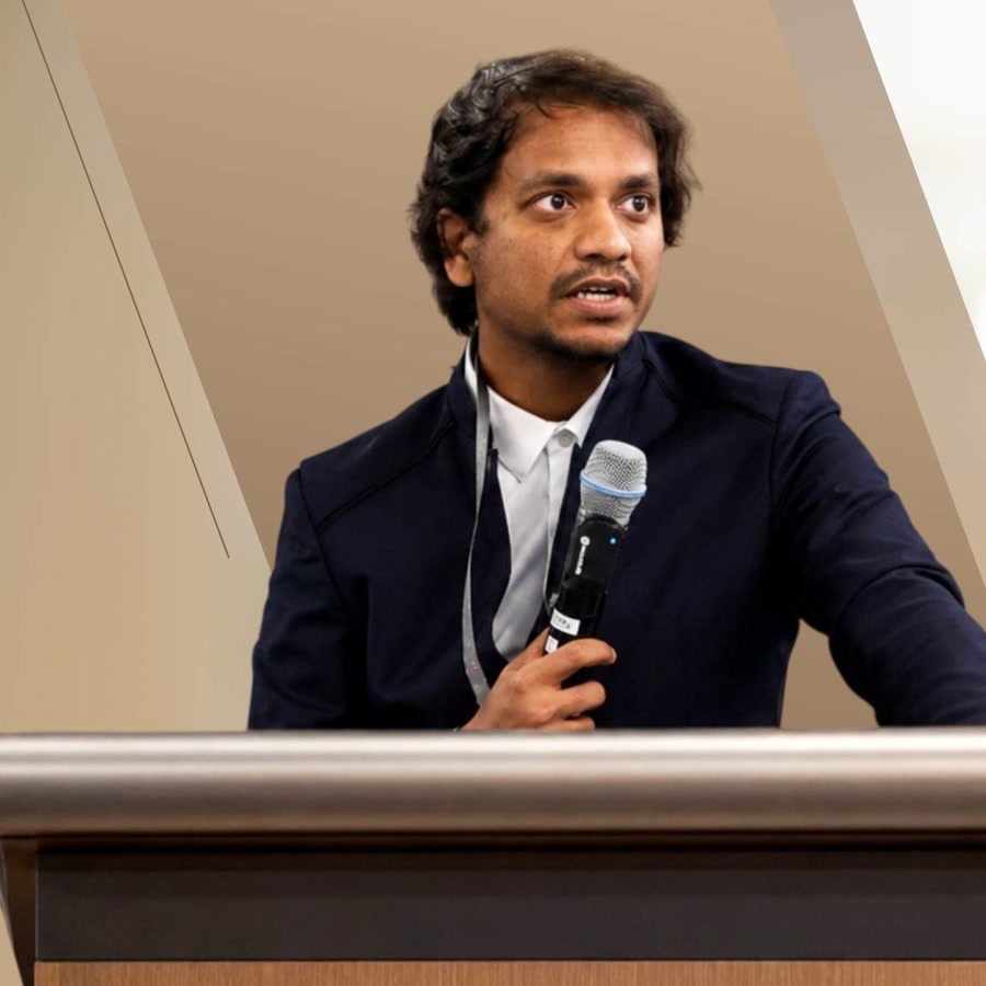 Hari Kishan presenting at a podium
